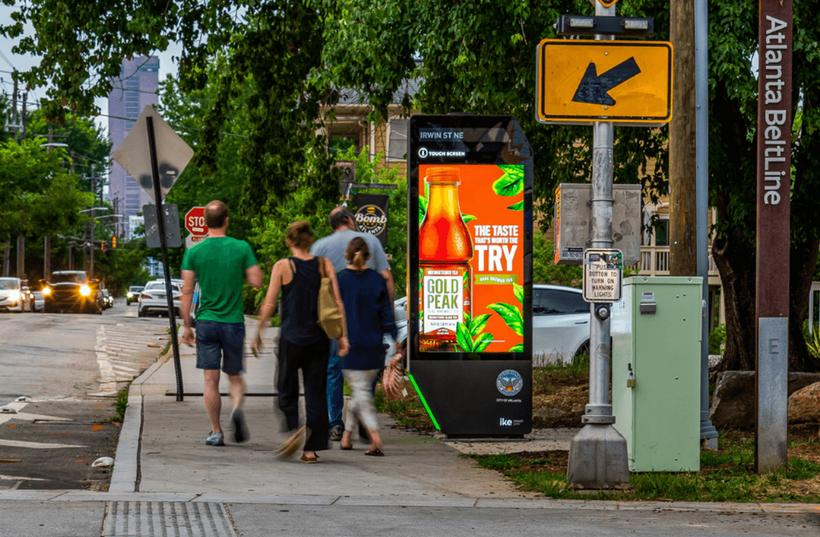 Street-level digital kiosk on a city sidewalk