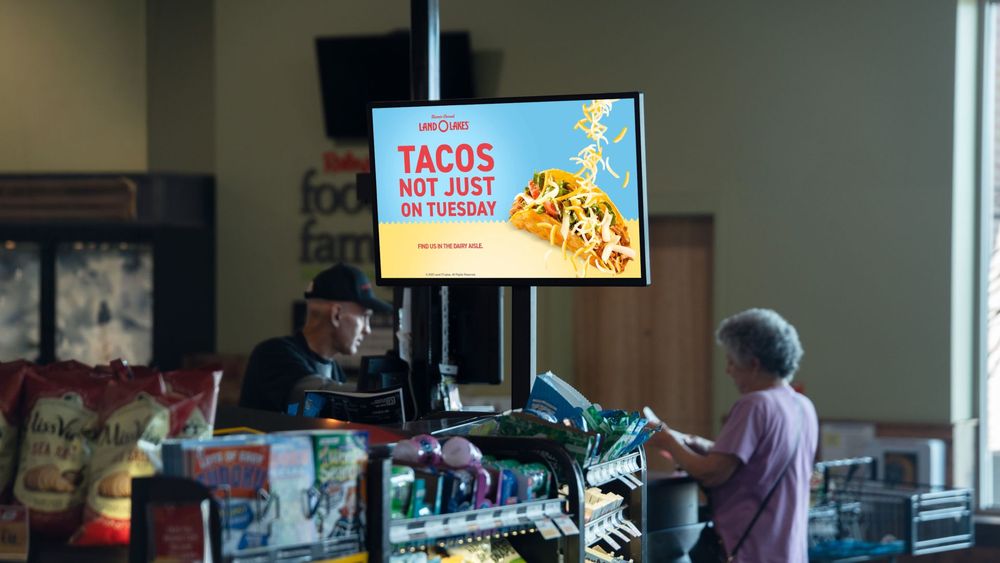 A digital screen at the service counter running a meal-occasion campaign.